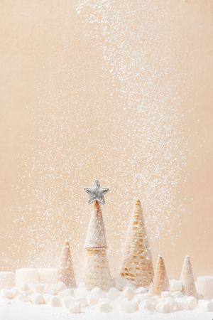Christmas or New Year background with Christmas tree of waffle cones and falling sugar snow