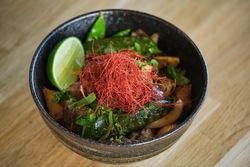 Asian dish with herbs in bowl