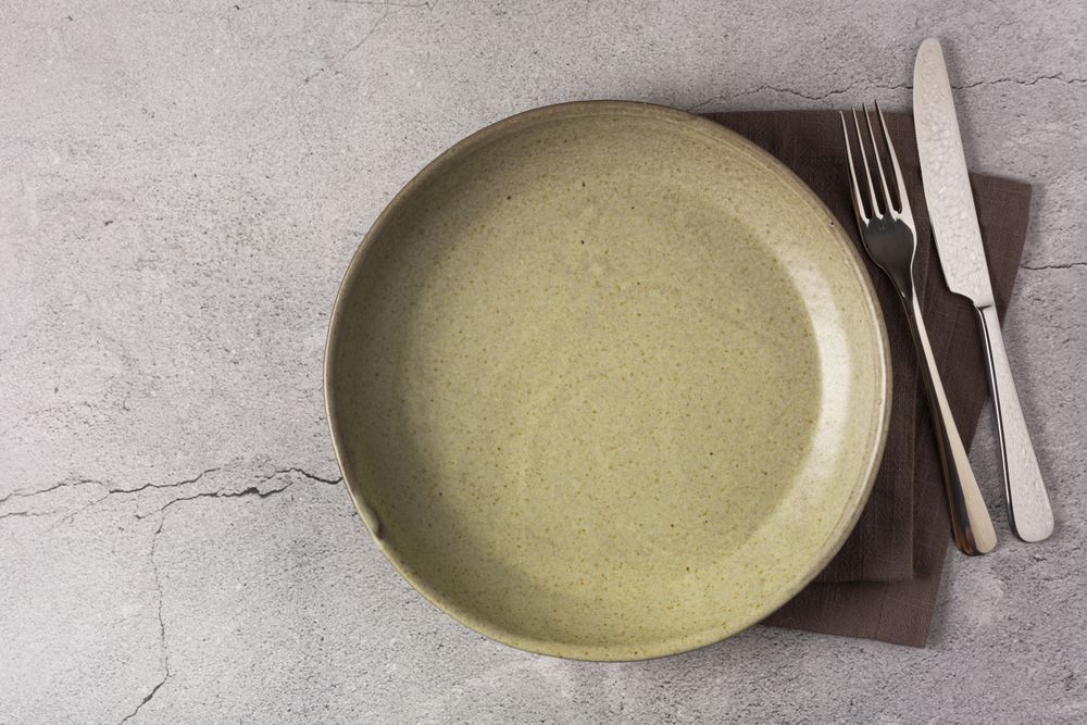 Empty plate on the slate table. Top view of the image.