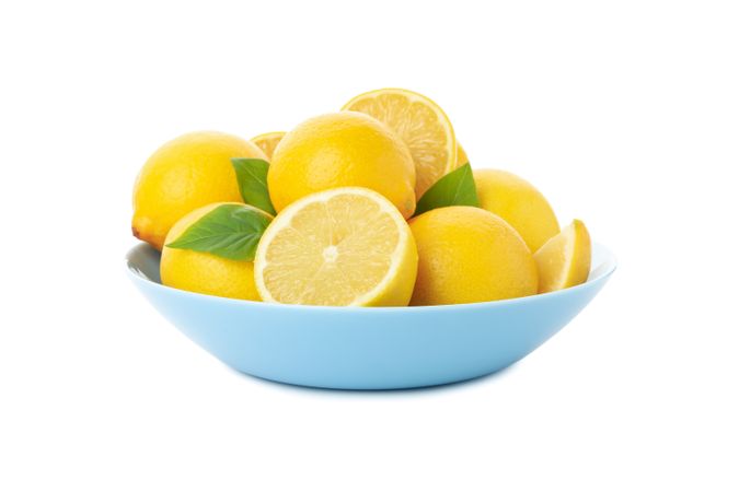 Plate with fresh lemons isolated on bright background