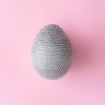 Disco ball Easter egg on pastel pink background