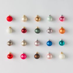 Rows of colorful Christmas bauble decorations on light background