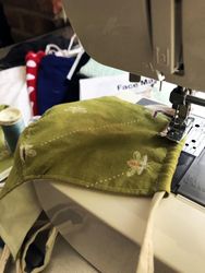 Fabric face mask being stitched on a sewing machine