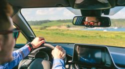 Young man holding steering driving