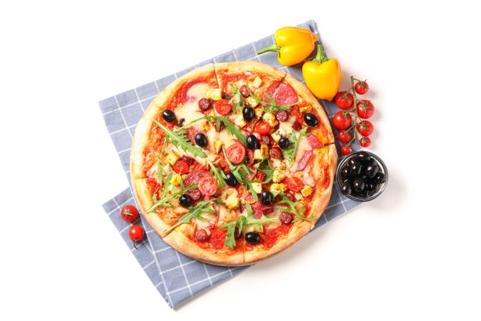 Tasty pizza, ingredients and towel isolated on blank background