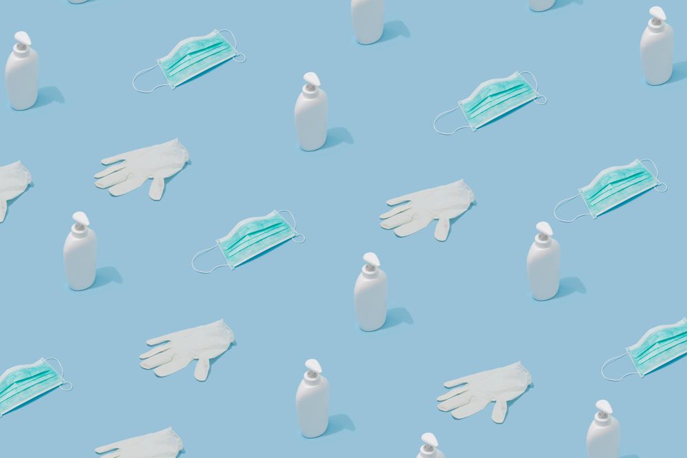 Pattern made with hand sanitizer, face mask and latex gloves