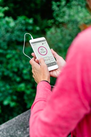 Athlete woman with earphones looking mobile