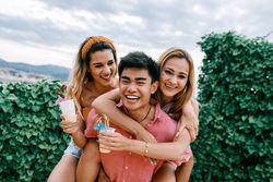 Happy man carrying his girlfriend on the back and having a good time