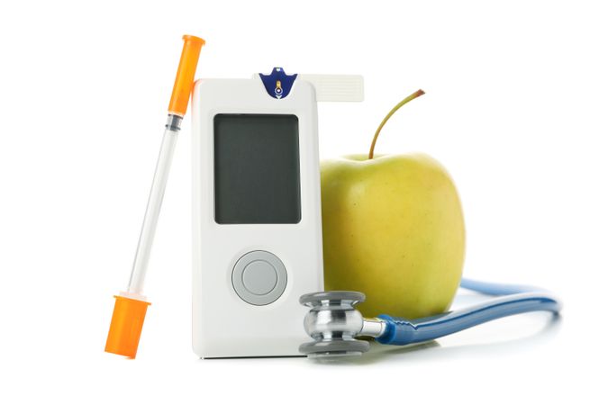 Blood glucose meter, syringe and apple isolated on blank background