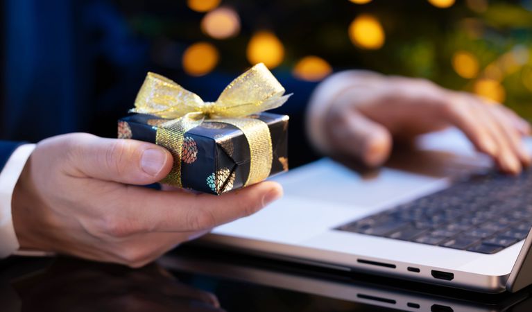 Businessman Holding Gift While Working