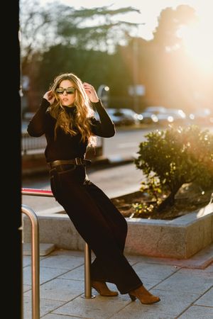 Stylish woman standing near metro station