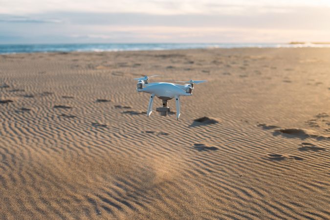Drone flying over sandy beach