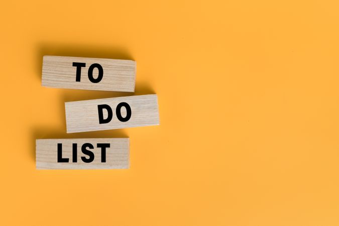 to do list words text on wooden blocks isolated on orange background. copy space