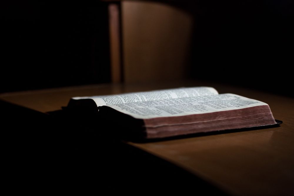 Open book on brown wooden table