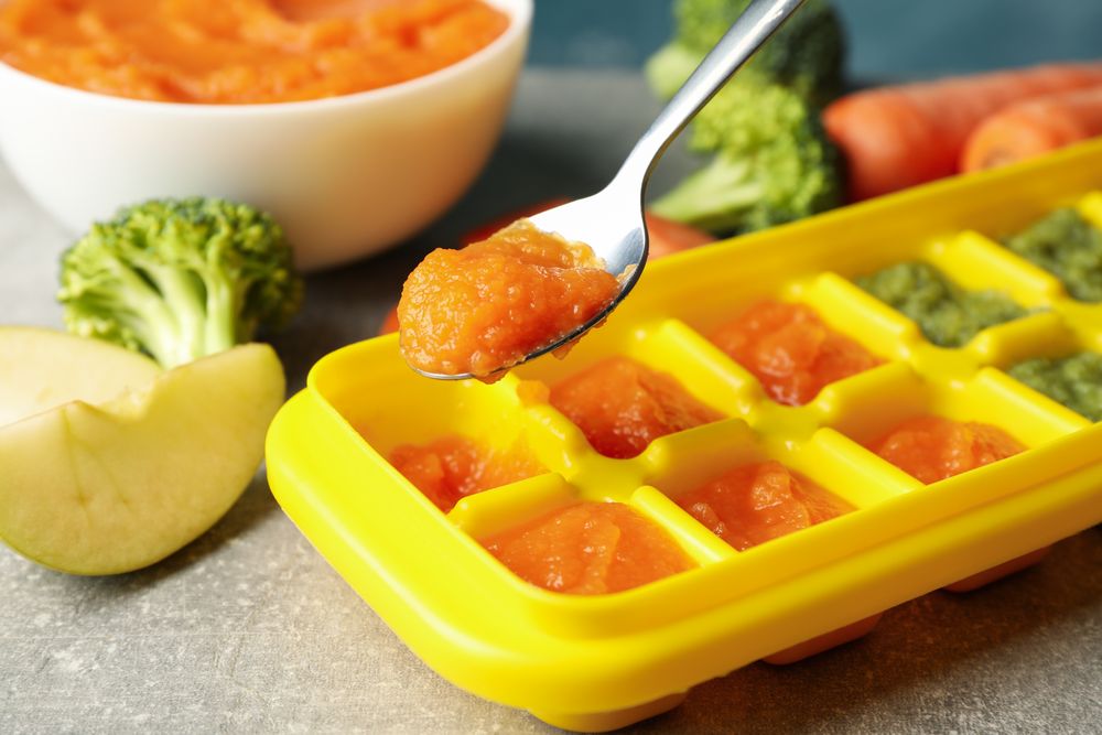 Composition with baby food on gray background, close up