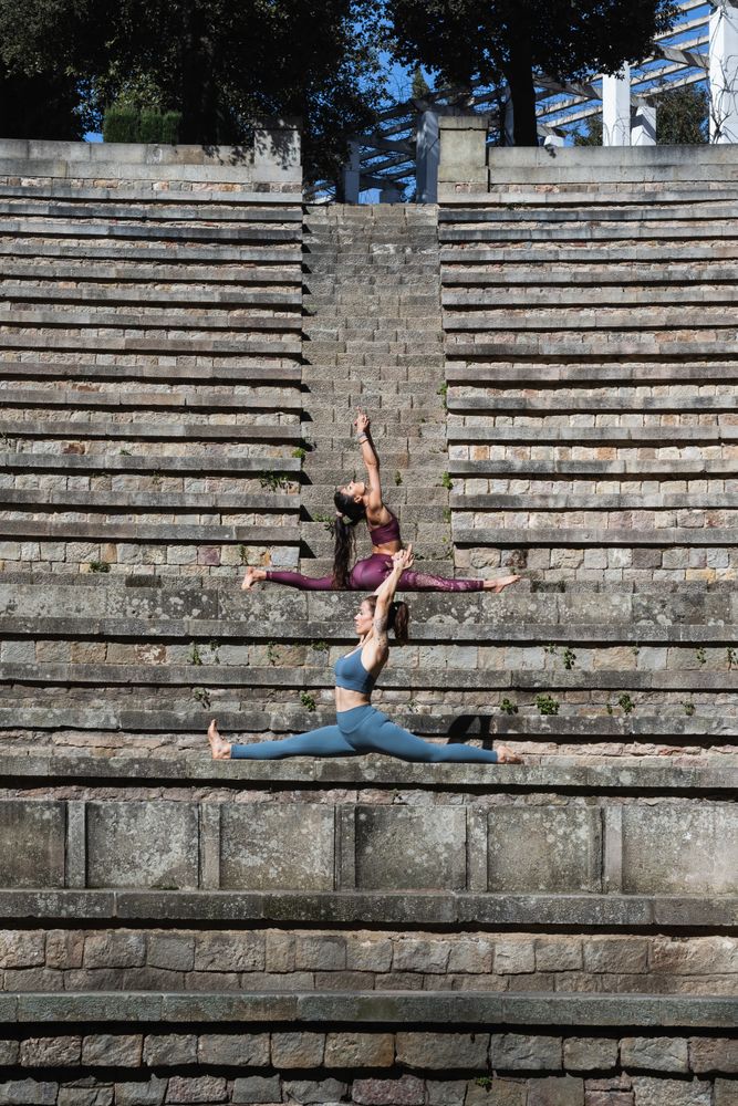 Flexible women sitting in Splits pose and doing yoga