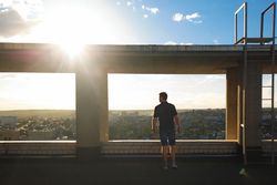 Silhouette of man in frame on top of building