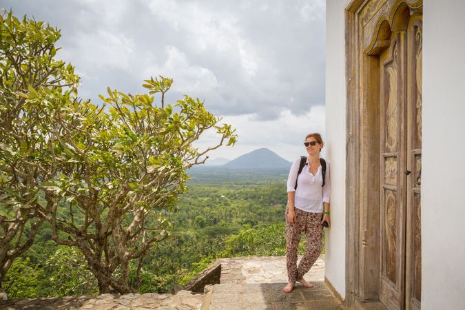 Woman leaning on old temple