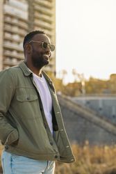 Black man with sunglasses, reflecting sunlight