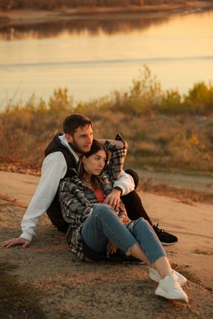 Couple sitting dusk countryside