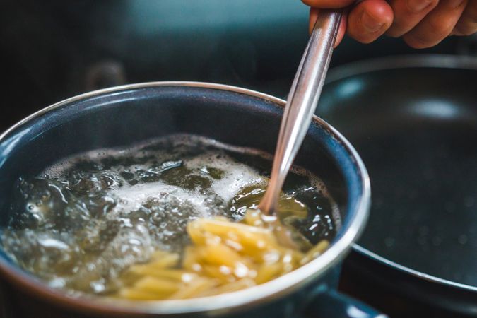 Pasta spilling into boiling water