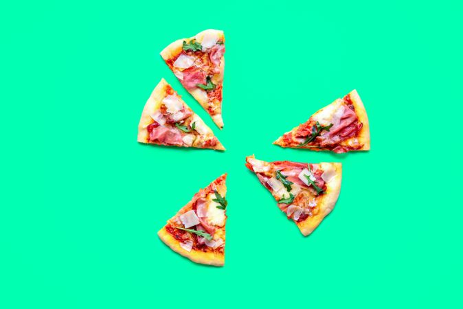 Pizza prosciutto slices minimalist on a green background