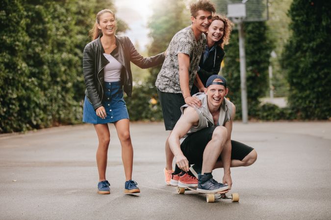 Man on skateboard with friends