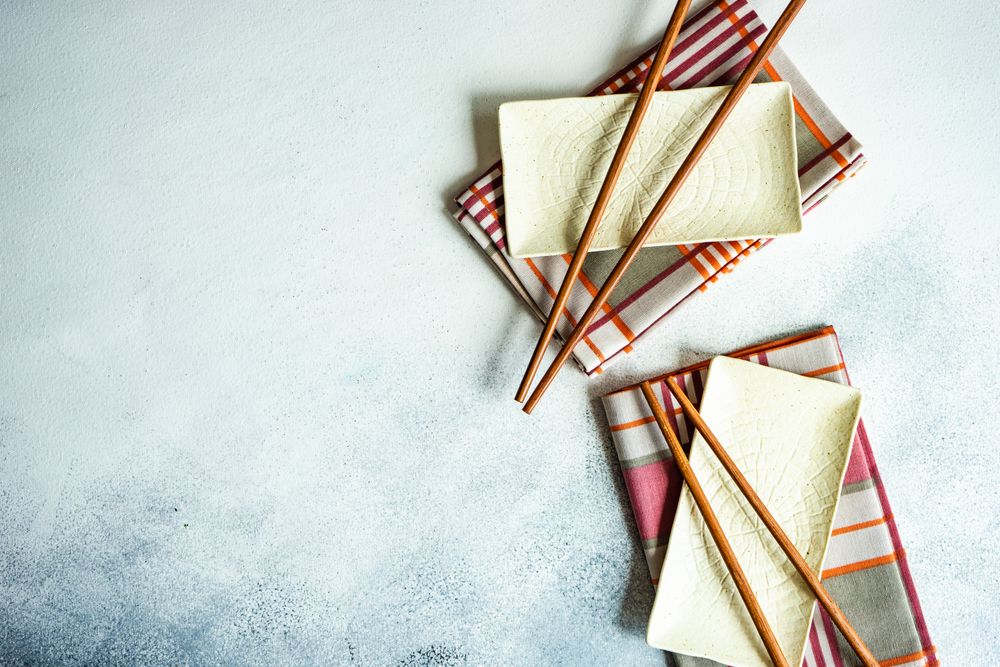 Top view of chopsticks on rectangular ceramic dishes