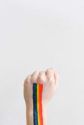 Cropped image of rainbow color painted on hand against light background bY7dj5