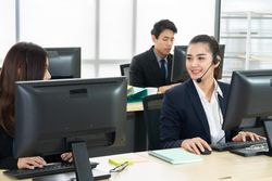Group of call center employees working in the office