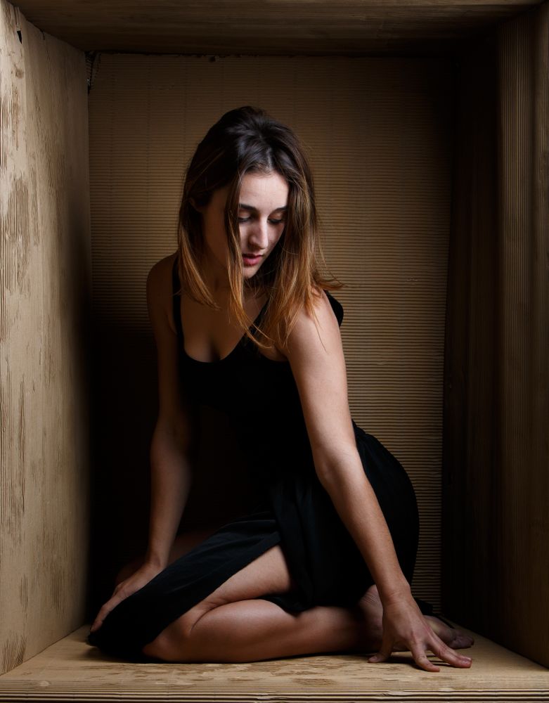 woman sitting in carton box