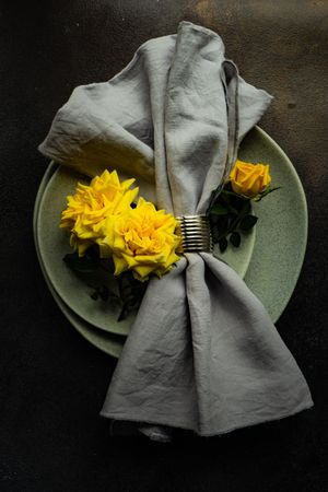 Grey table setting with yellow roses