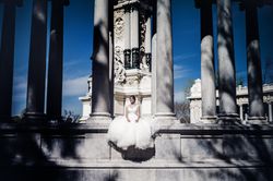 Smiling fiancee sitting near columns