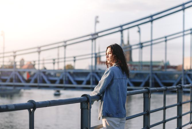 Woman standing at the railing along the waterfront
