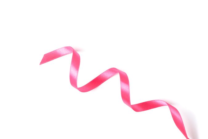 Pink ribbon isolated on studio background. Gift concept