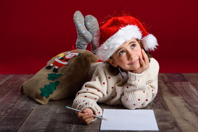 Child writing a letter to Santa at Christmas time