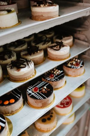 Shelves with delicious cakes in bakery
