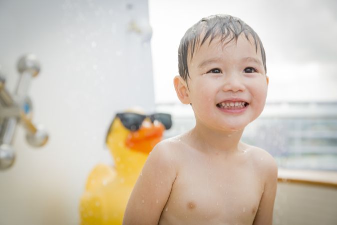 Happy boy playing in the water at park