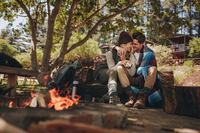Couple in love sitting near a bonfire