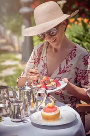 Woman Enjoying Breakfast in the Garden