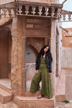 Woman on street between ancient buildings