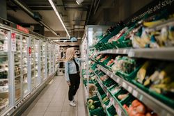 Mature woman choosing vegetables in the produce aisle