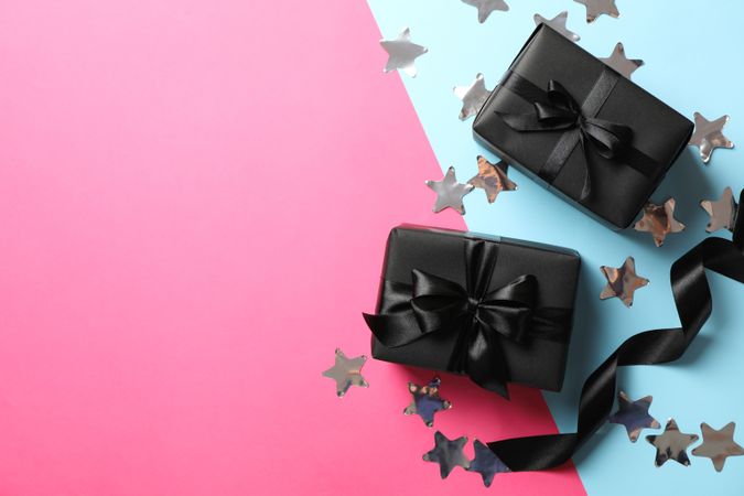 Gift boxes with dark bow on two tone background