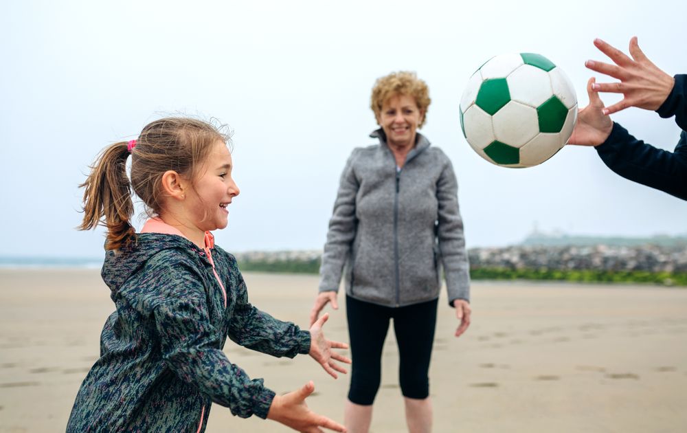 Three generations playing on the beach