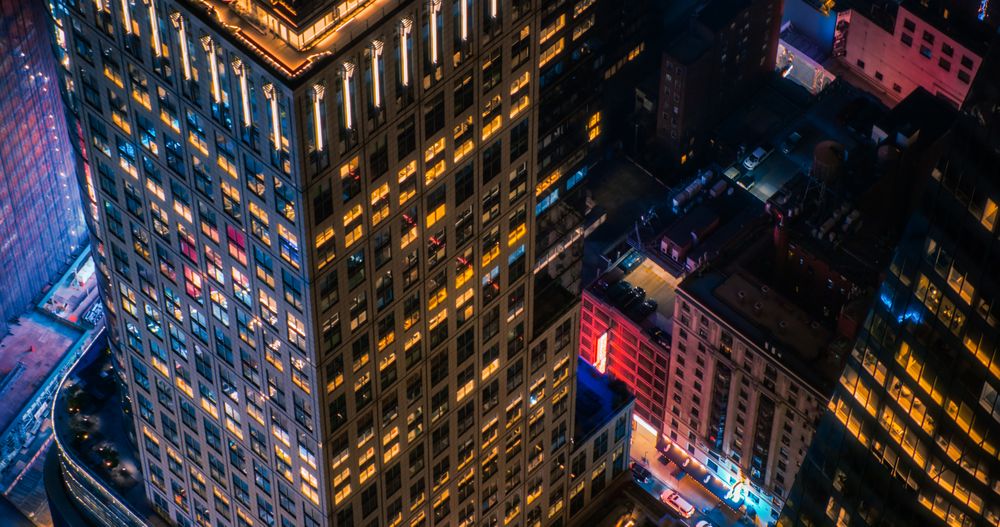 High Angle Aerial Helicopter Photo Over Midtown Manhattan Skyscrapers Cityscape with Lights from Windows, Illumination, Advertising Billboards. Beautiful Night in New York City