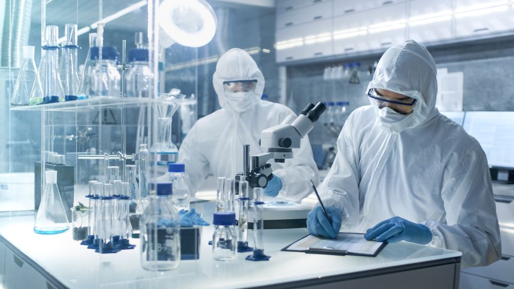 In a Secure High Level Laboratory Scientists in a Coverall Conducting a Research.