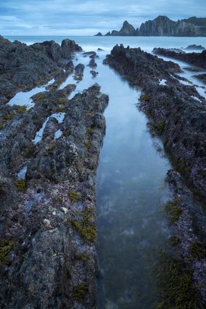 Foggy landscape of Playa de Gueirua rock seashore