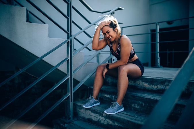 Young woman sitting on stadium stairs