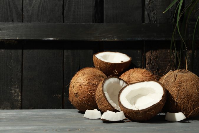 Coconut on wooden background, space for text. Tropical fruit