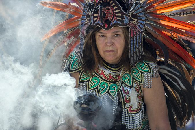 Des Moines, Iowa, USA - September 26, 2015: An Aztec healer holds a cauldron of cleansing smoke